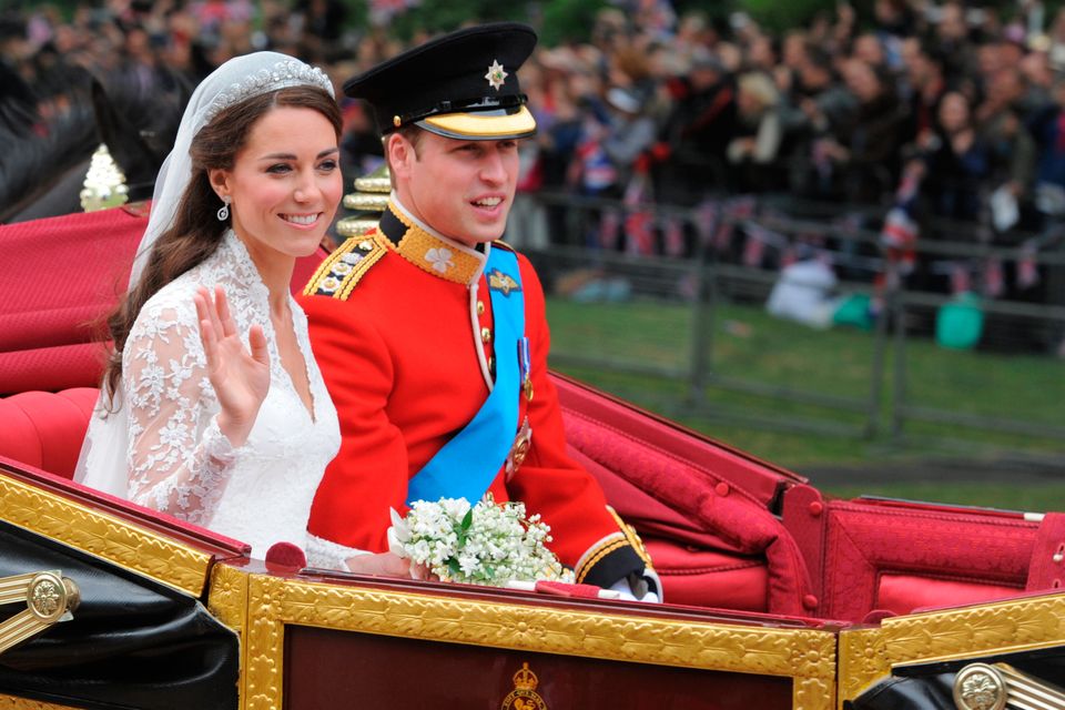 Prince William and his wife Kate, Duchess of Cambridge, travelling in the 1902 State Landau carriage along the Processional Route to Buckingham Palace after their wedding service at Westminster Abbey, in London: Dimitar Dilkoff/PA Wire