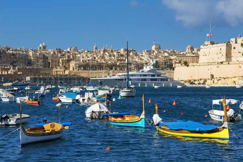 Take a tour of the Grand Harbour in a colourful water taxi, called a dghajsa. Photo: Getty