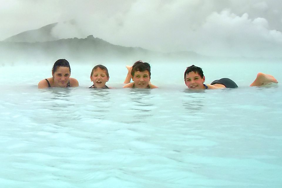 Iceland: Family bathing in a geothermal pool