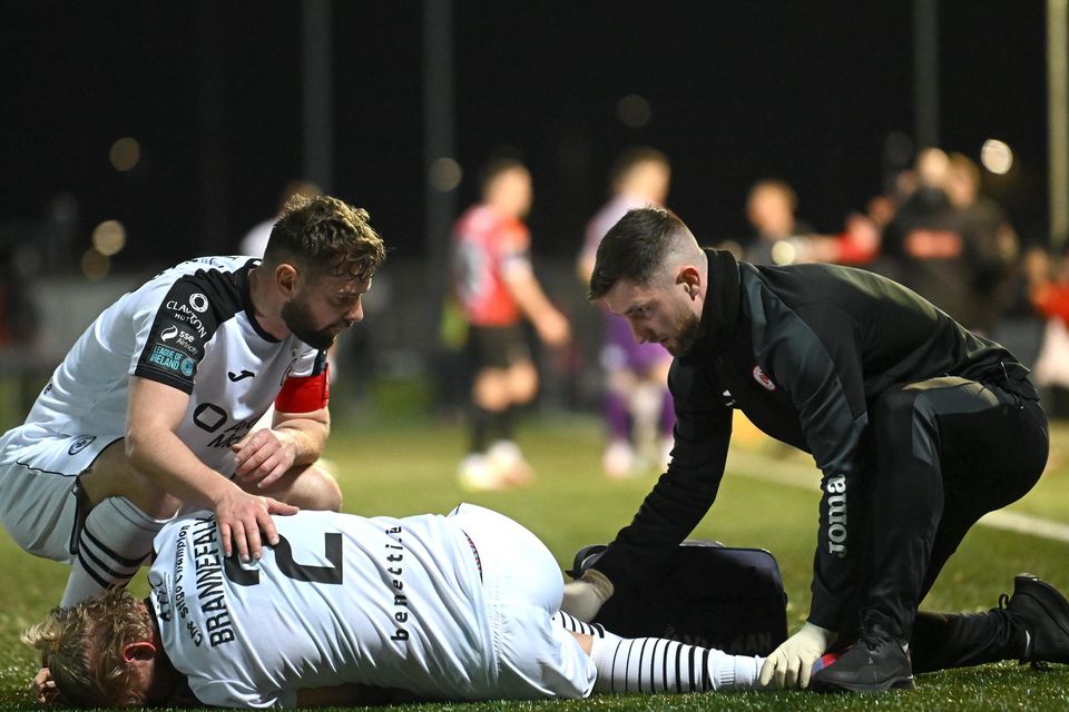 Johan Brannefalk of Sligo Rovers is attended to by physiotherapist Cian McBride as team-mate Greg Bolger comforts him during the SSE Airtricity Men's Premier Division match between Derry City and Sligo Rovers at The Ryan McBride Brandywell Stadium in Derry. Pic: Stephen McCarthy/Sportsfile