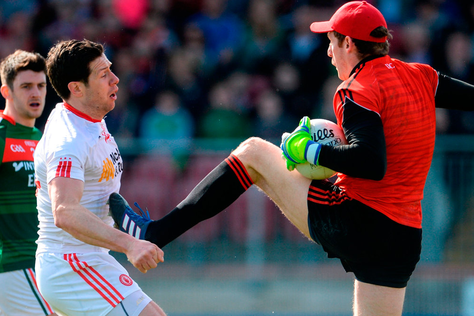 David Clarke of Mayo and Tyrone’s Sean Cavanagh (left) clash in Omagh. Photo: Oliver McVeigh/Sportsfile