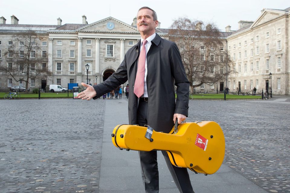 Col Chris Hadfield with his guitar in Trinity College Dublin.