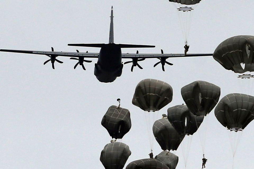 US and Serbian army paratroopers jump from a US Air Force transport aircraft at Lisicji Jarak Airport (AP)
