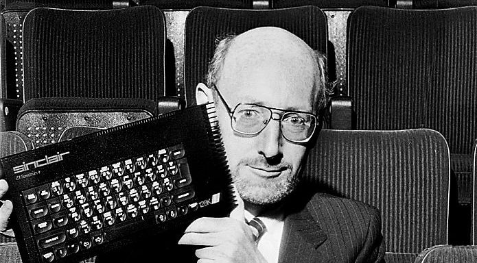 Sinclair founder Sir Clive Sinclair holds up a Sinclair ZX Spectrum 128 home computer, United Kingdom, 1986. (Photo by Dick Barnatt/Getty Images)