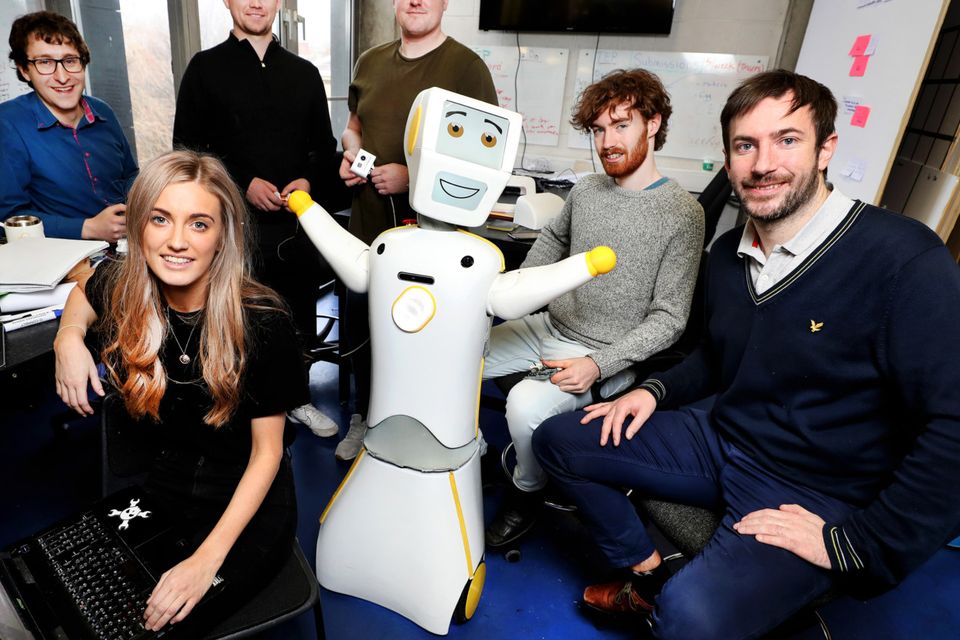 Stevie The Robot at the Robotics and Innovation Lab (RAIL) at TCD with his team (from left), Dr Michael Culligan, Niamh Donnelly, Andrew Murtagh, Eamonn Burke, Cian Donovan and Prof Conor McGinn. Photo by Steve Humphreys