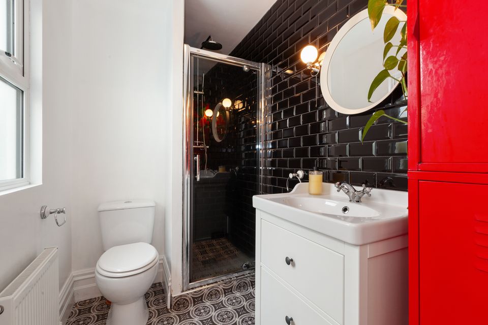 The ground floor shower room with black London tiles