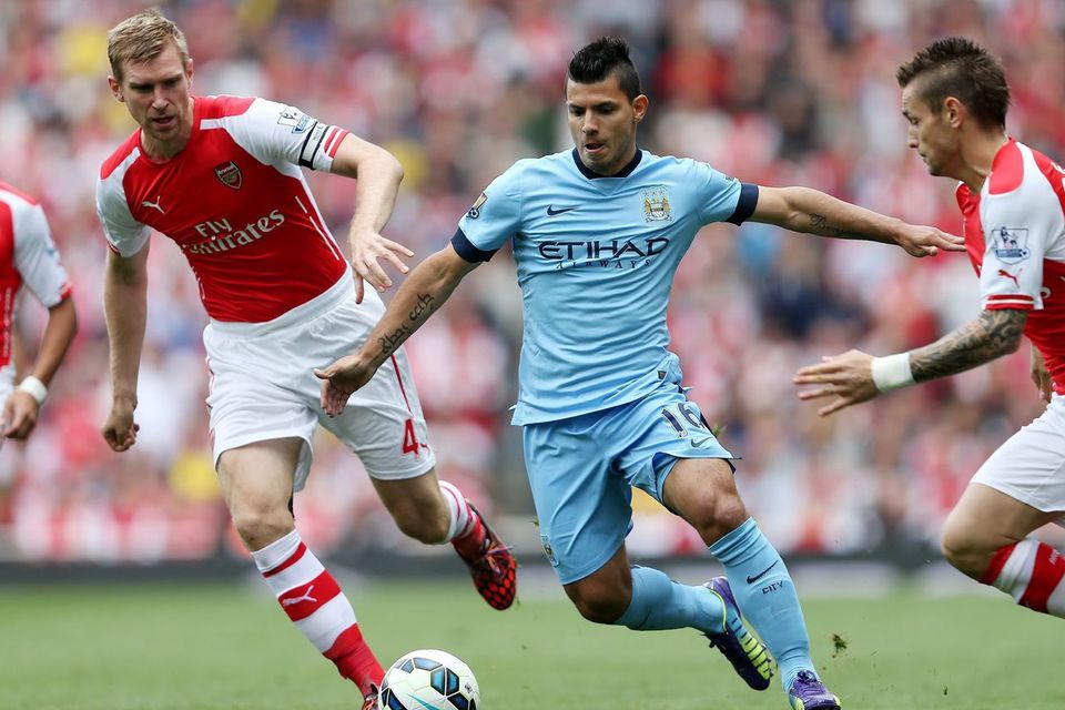 Manchester City's Sergio Aguero (right) is challenged by Arsenal's Per Mertesacker and Mathieu Debuchy
