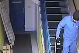 thumbnail: One of the two thieves leaves the wholesaler’s premises with a security box containing around €60,000