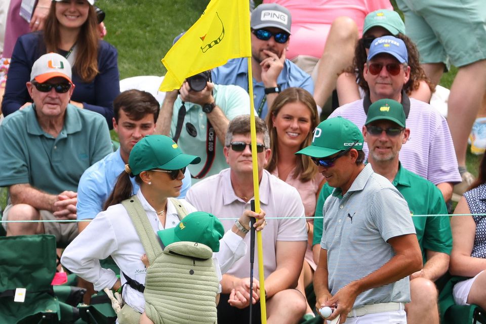 Rickie Fowler of the U.S. with Annie Verret, wife of Jordan Spieth of the U.S. on the fifth hole during the par 3 contest