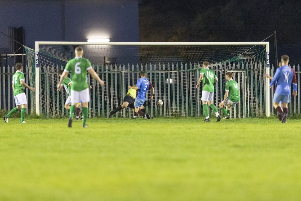 Daniel McCann of St. Anthony's turns the ball into his own net for Wicklow Rovers' third goal.  