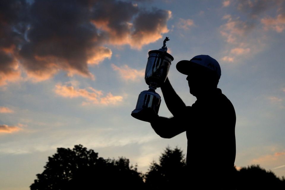 Dustin Johnson with the trophy. Photo: AP