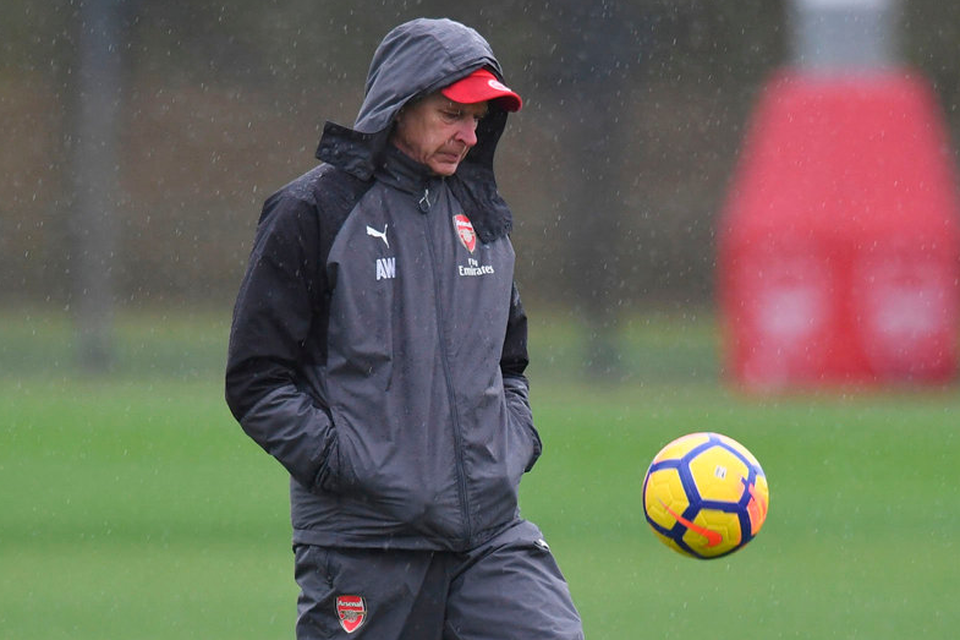 Arsene Wenger enjoys a private moment during training yesterday. Photo: Getty Images