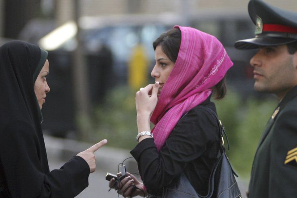 The 'morality police' in Tehran question a woman over her headscarf. Photo: AFP