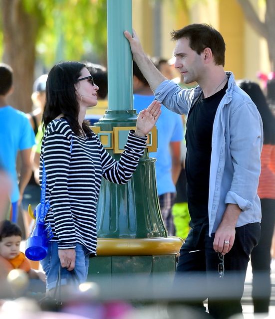 EXCLUSIVE: Courteney Cox and her fiance Johnny McDaid spend a day at Disneyland with Courteney's daughter Coco. Johnny McDaid was seen wearing a ring on his wedding ring finger. are they married already?