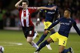 thumbnail: Sheffield United's Jamie Murphy is challenged by Southampton full-back Nathaniel Clyne during their Capital One Cup quarter-final clash at Bramall Lane. Photo: REUTERS/Andrew Yates