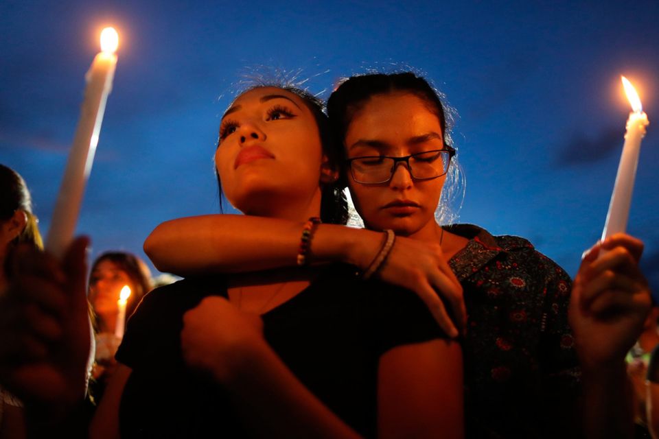 Grief: People attend a candlelight vigil for the victims of the mass shooting in El Paso, Texas