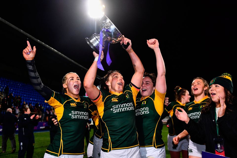 Railway Union players, from left, Aoife Doyle, Lindsay Peat and Katie O'Dwyer celebrate with the cup after the Energia women's AIL final in 2022