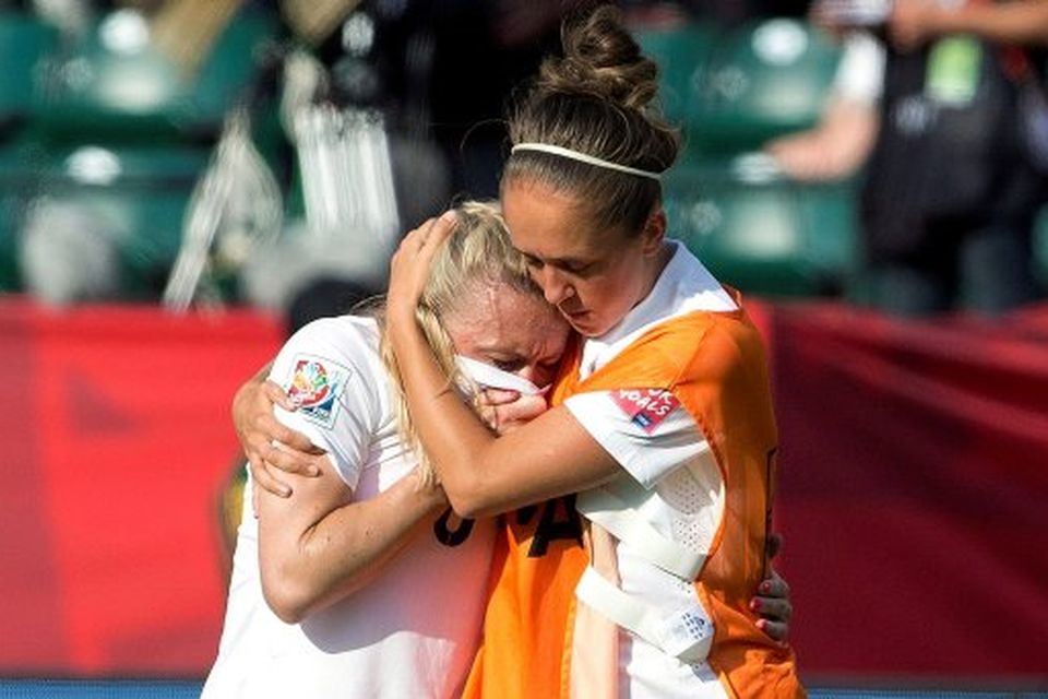 England's Josanne Potter, right, consoles Laura Bassett (6) after a 2-1 loss to Japan in a semifinal in the FIFA Women's World Cup soccer tournament, Wednesday, July 1, 2015, in Edmonton, Alberta, Canada