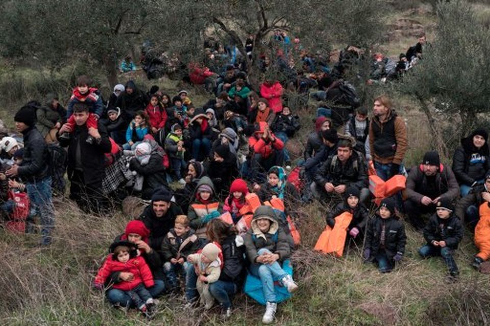 Migrants wait to travel to the Greek island of Lesbos, near the Aegean town of Ayvacik, Turkey, Friday, Jan. 29, 2016