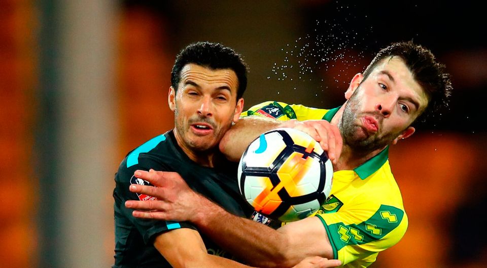 Grant Hanley of Norwich City is challenged by Pedro of Chelsea    Photo: Getty