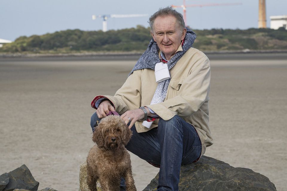 Gerry Grennell with his dog Millie taking a walk at Sandymount in Dublin. Photo: Arthur Carron