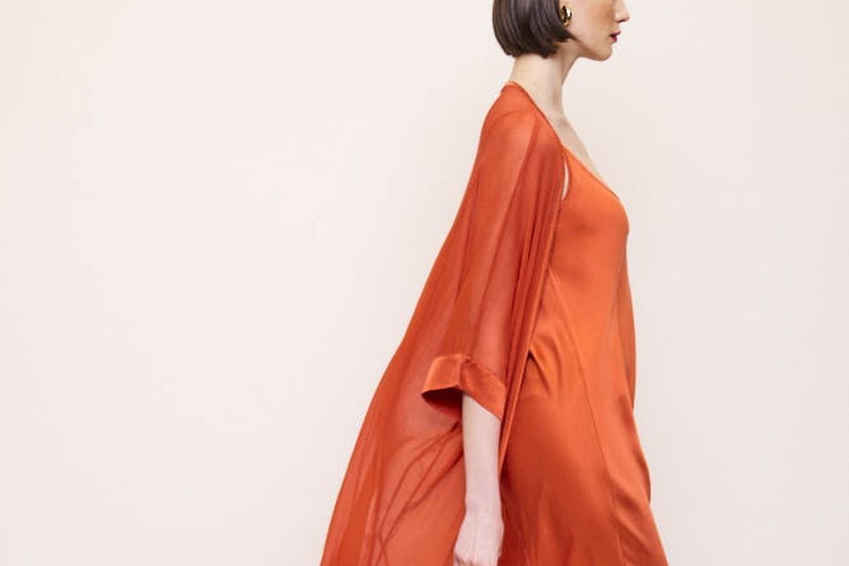 Silk bias cut maxi dress in a firey orange, €325, worn with drape jacket, €235, ecrustudios.com  