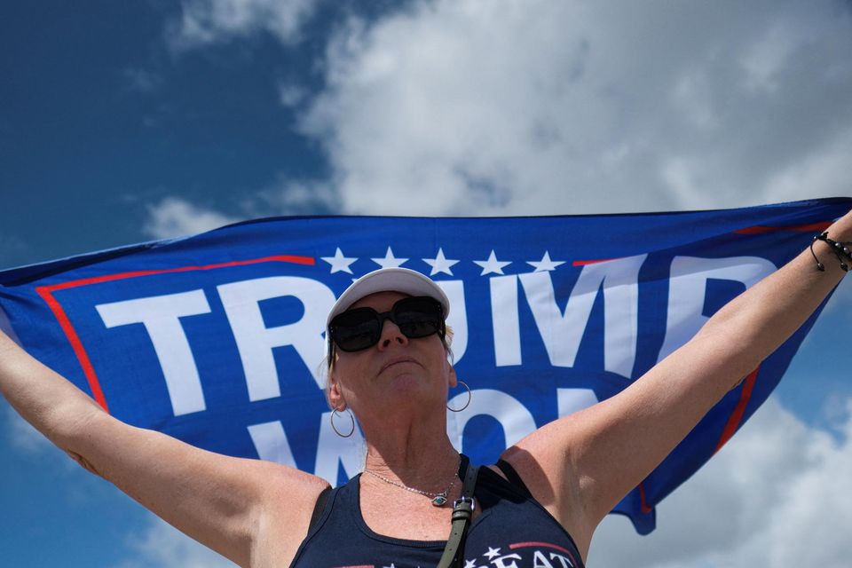 If the US courts and the people resist the inevitable incitements and bombast they will achieve a passing grade. Above, a Trump supporter outside his Mar-a-Lago resort yesterday. Photo: Ricardo Arduengo/Reuters