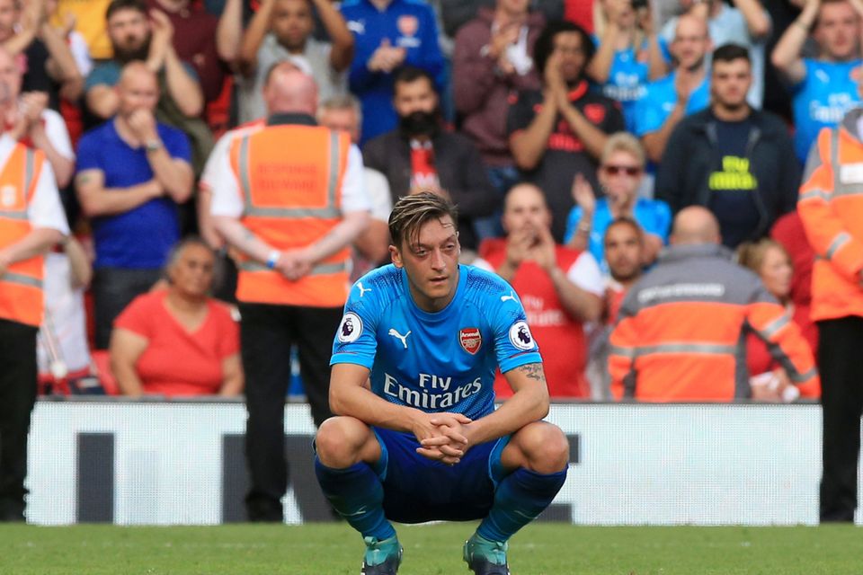 Arsenal's Mesut Ozil shows his dejection after the final whistle