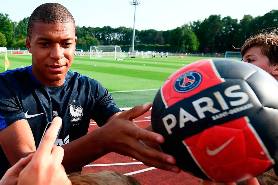 Kylian Mbappe signs autographs before a training session in Clairefontaine en Yvelines. Photo: AFP/Getty Images