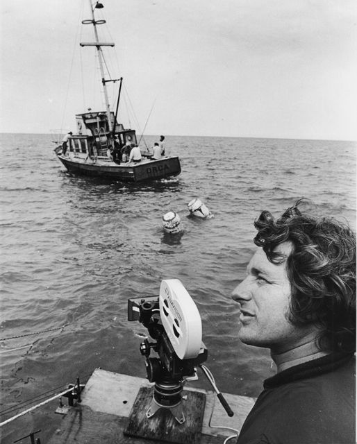 Director Steven Spielberg waits for a scene to begin filming on 'Jaws'