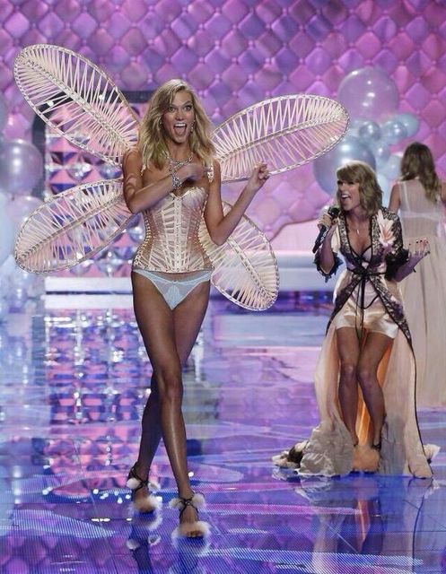 Singer Taylor Swift (R) performs as model Karlie Kloss presents a creation during the 2014 Victoria's Secret Fashion Show