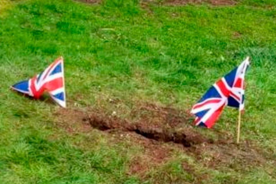 Union flags mark the spot where the Irish language sign was removed from in Mill Park, Tobermore.