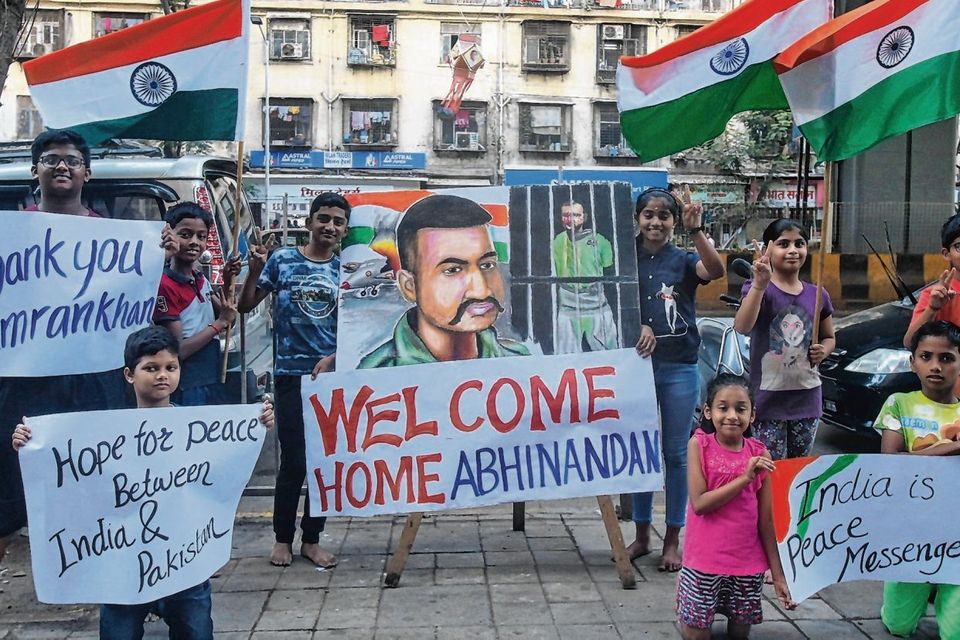 Welcome news: Children hold banners and flags on a street in Mumbai after Pakistan said it would release an Indian air force pilot today. Photo: Francis Mascarenhas/Reuters