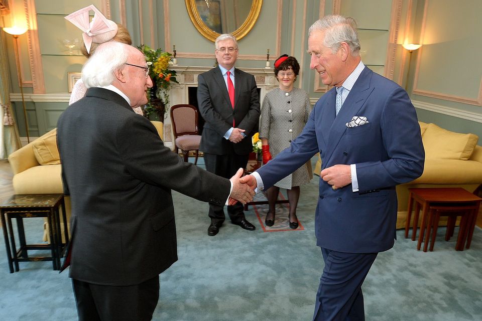 President Michael D Higgins shakes hands with the Prince Charles, who welcomed him to the UK for a five day state visit, at the Irish Embassy in central London