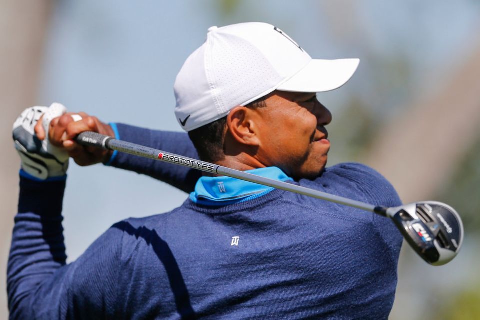 Re-take: Tiger Woods reheats his drive on the third hole after going out of bounds during the first round of the Arnold Palmer Invitational golf tournament at Bay Hill yesterday