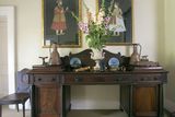 thumbnail: The hall is furnished with a treasure trove of old pieces. The desk is from Drishane Castle, home of one branch of Robert‘s family. The art is a mix of Moghul art and family heirlooms