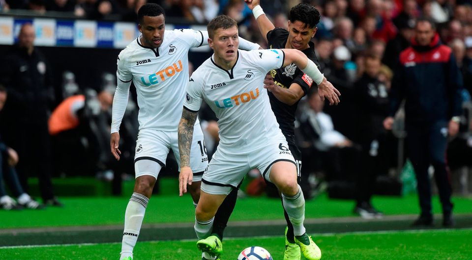 Swansea City's Alfie Mawson and Martin Olsson in action with Newcastle United’s Ayoze Perez. Photo: Reuters/Rebecca Naden