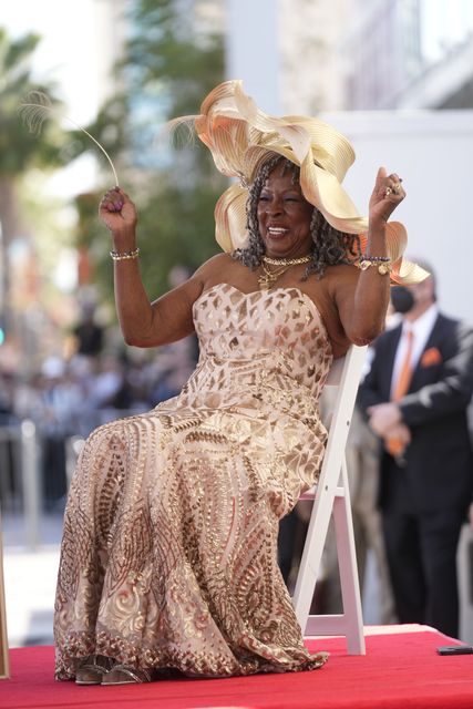 Motown star Martha Reeves celebrates as she is honoured with a star on the Hollywood Walk of Fame (Damian Dovarganes/AP)