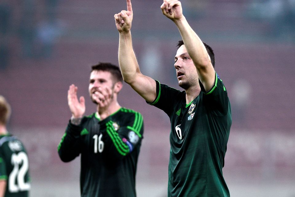 Chris Baird celebrates Northern Ireland's victory in Greece. Photo credit: LOUISA GOULIAMAKI/AFP/Getty Images