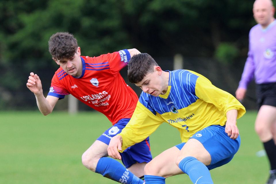 James Doyle of Curracloe United keeping tabs on Darragh Kent of Campile.