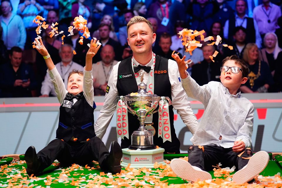 Kyren Wilson celebrates with children Finley and Bailey after winning the final on day 17 of the 2024 Cazoo World Snooker Championship at the Crucible Theatre, Sheffield