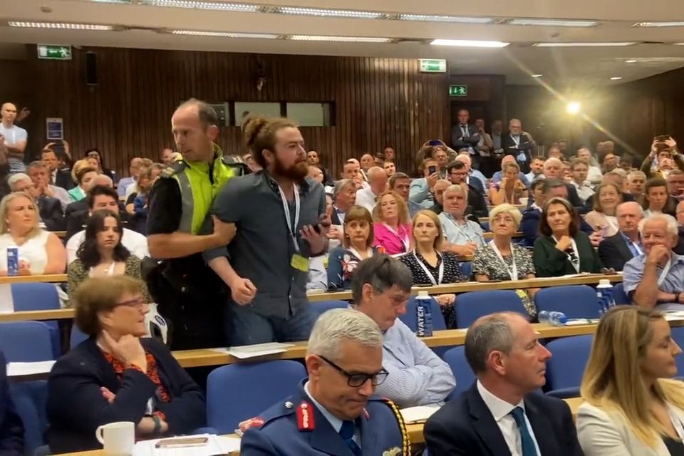 A row broke out between the Foreign Affairs minister and demonstrators, a number of which were some minutes later removed by gardaí