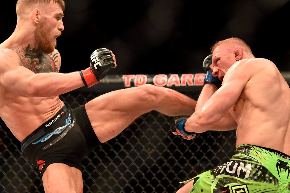 18 January 2015; Conor McGregor, left, in action against Dennis Siver. UFC Fight Night, Conor McGregor v Dennis Siver, TD Garden, Boston, Massachusetts, USA. Picture credit: Ramsey Cardy / SPORTSFILE