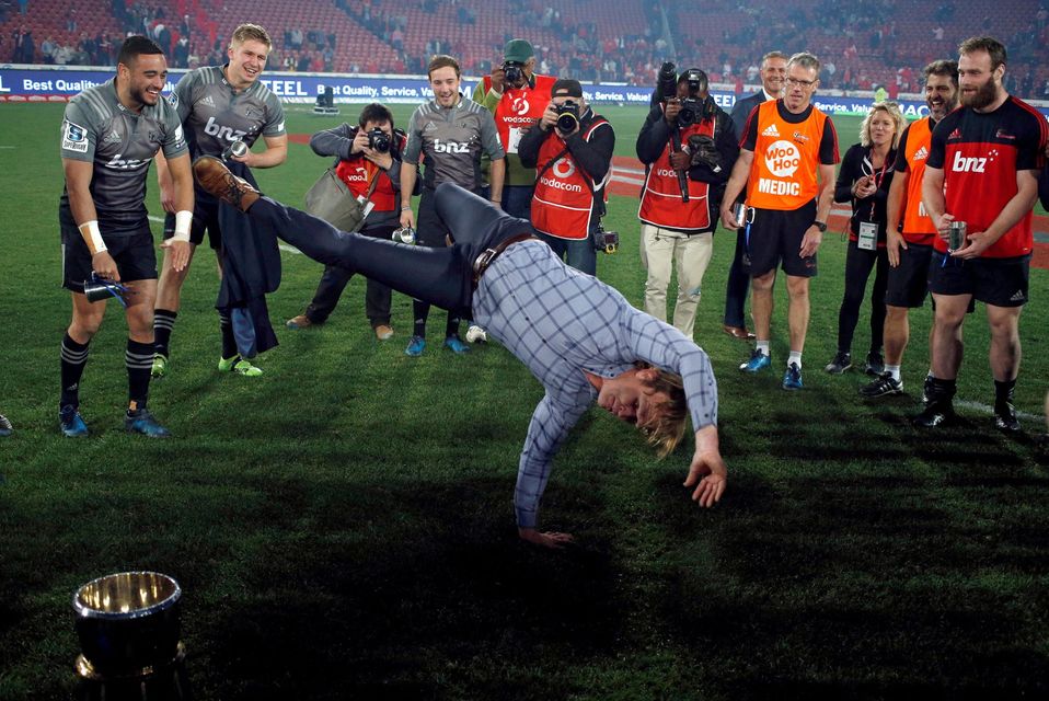 Crusaders Head coach Scott Robertson breakdances in front of the trophy after winning the Super Rugby final in 2017. Photo: Reuters