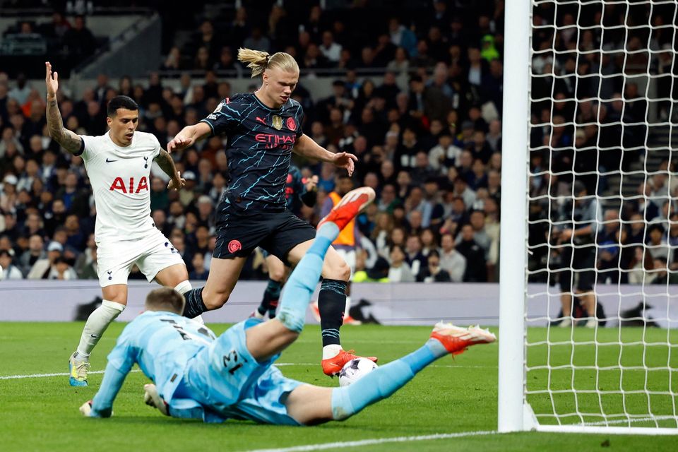 Erling Haaland scores Manchester City's first goal past Tottenham's Guglielmo Vicario. Photo: Reuters
