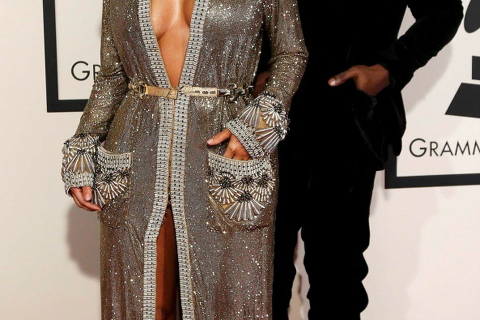 Rapper Kanye West and Kim Kardashian arrive at the 57th annual Grammy Awards in Los Angeles, California February 8, 2015.