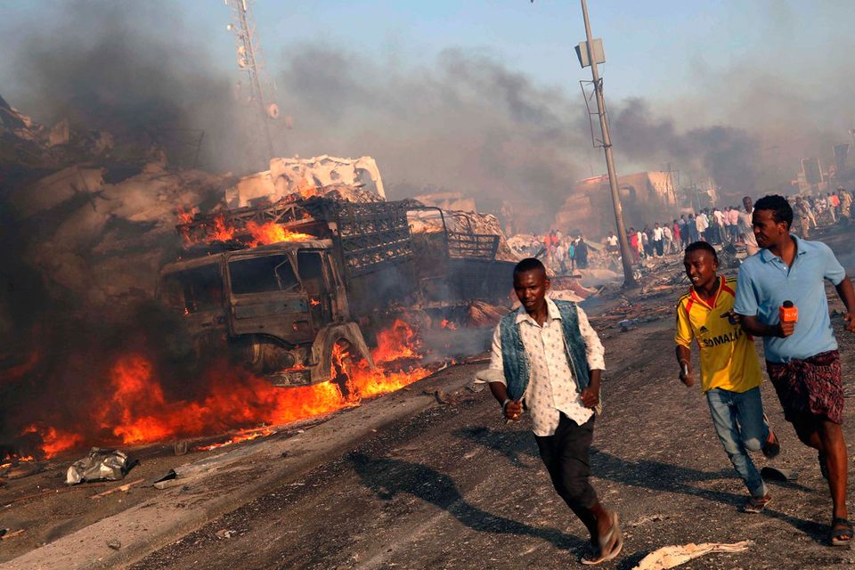 Civilians evacuate from the scene of an explosion in KM4 street in the Hodan district of Mogadishu, Somalia October 14, 2017. REUTERS/Feisal Omar/File Photo