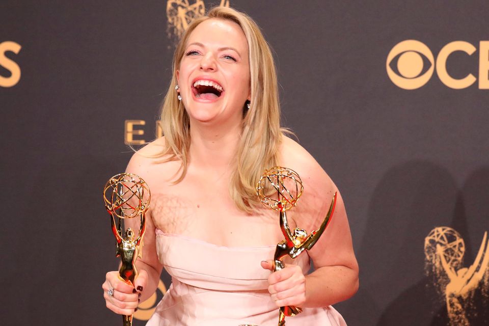 Elisabeth Moss poses with her Emmys for Outstanding Lead Actress in a Drama Series and Outstanding Drama Series for The Handmaid's Tale. REUTERS/Lucy Nicholson