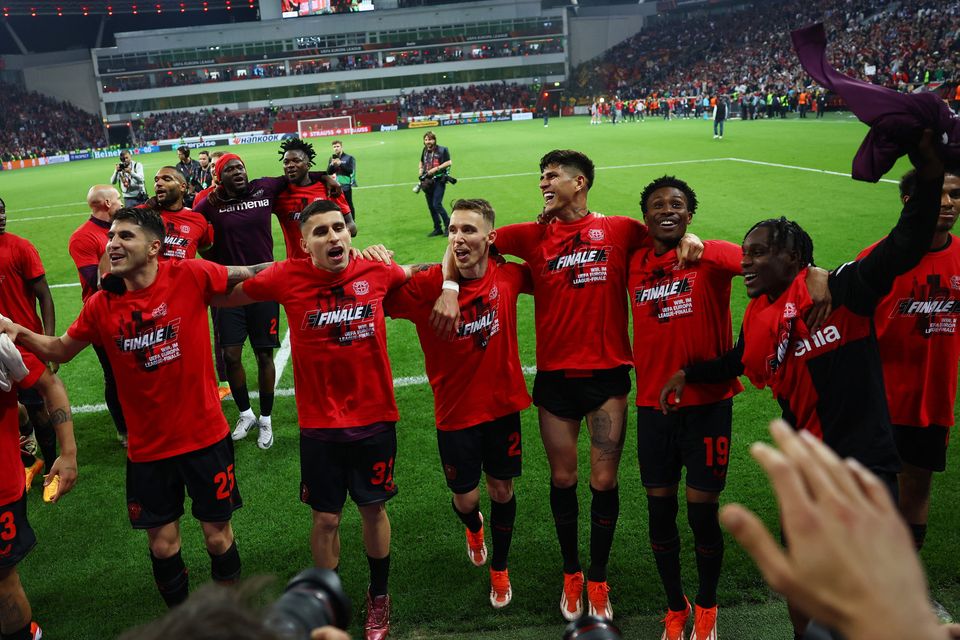 Bayer Leverkusen's Alejandro Grimaldo with teammates celebrate after the match