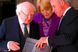 thumbnail: Irish President Michael Higgins, left, and his wife Sabina are presented with a book from Director of the Australian War Memorial Brendan Nelson during an official visit to the Australian War Memorial in Canberra, Monday, Oct. 16, 2017. (David Gray/Pool Photo via AP)